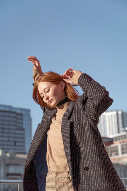 Femme posant à l'extérieur contre le ciel