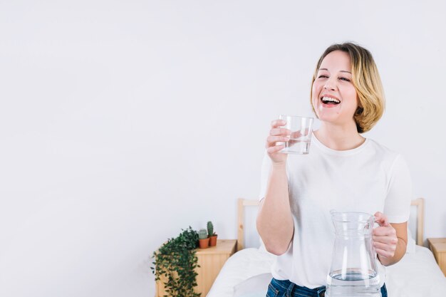 Femme qui riante avec de l&#39;eau dans la chambre