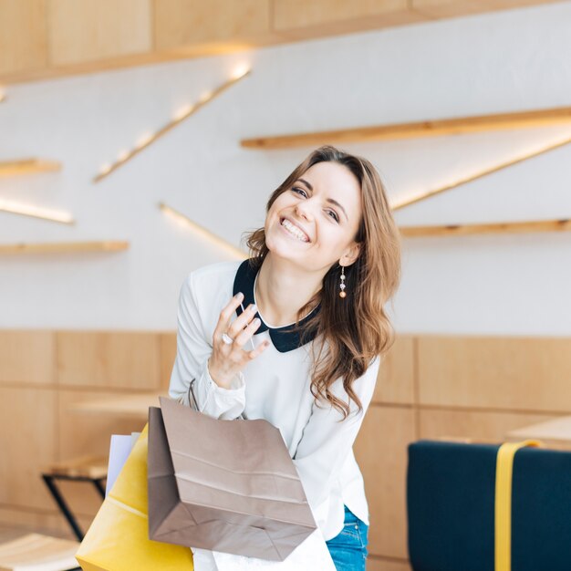 Femme qui riante avec des sacs en papier