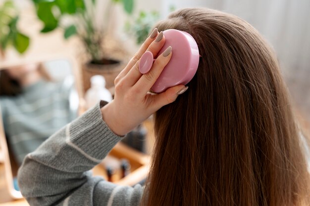 Une femme qui se fait un massage du cuir chevelu.