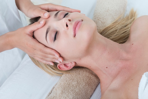 Femme recevant un massage du visage dans un spa