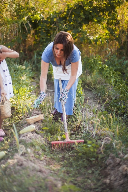 Photo gratuite femme récoltant une courge dans le champ