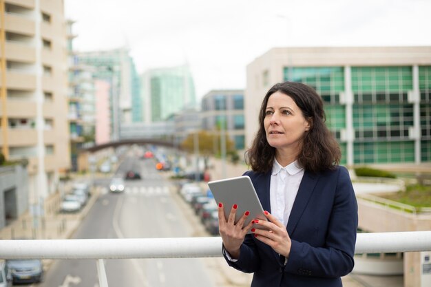 Femme réfléchie à l'aide de tablet pc