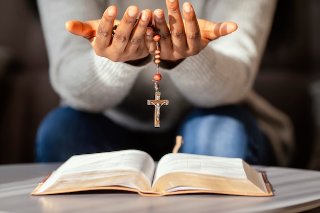 Femme religieuse priant avec chapelet