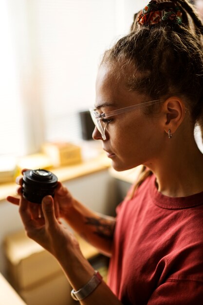 Femme réparant la vue latérale de l'appareil photo photo