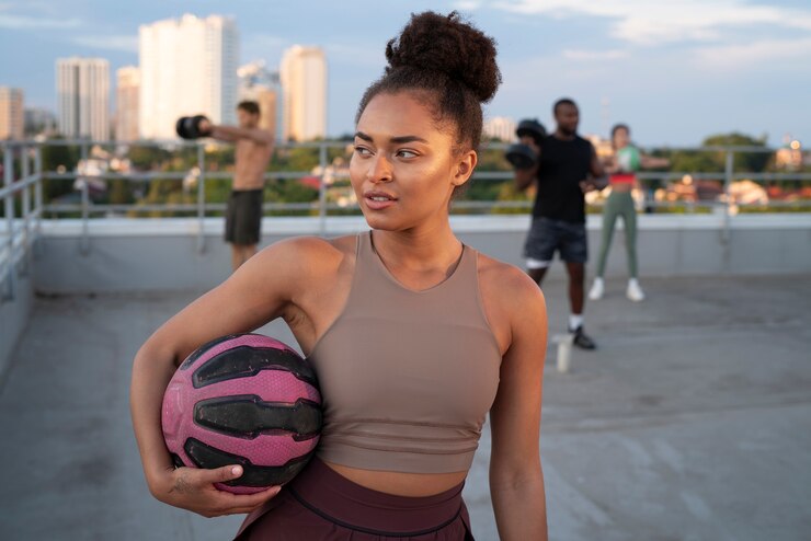 Photo gratuit femme s'entraînant à l'extérieur avec une balle