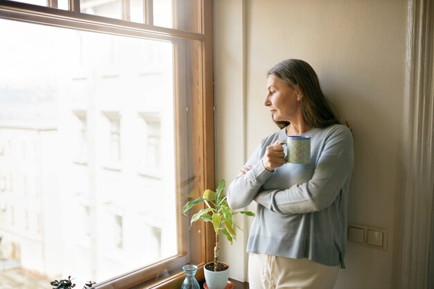 Femme senior expressive posant à l'intérieur