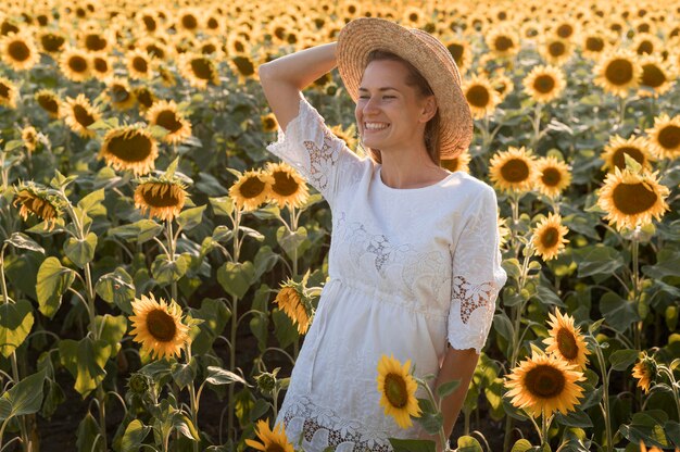 Femme smiley coup moyen posant avec chapeau