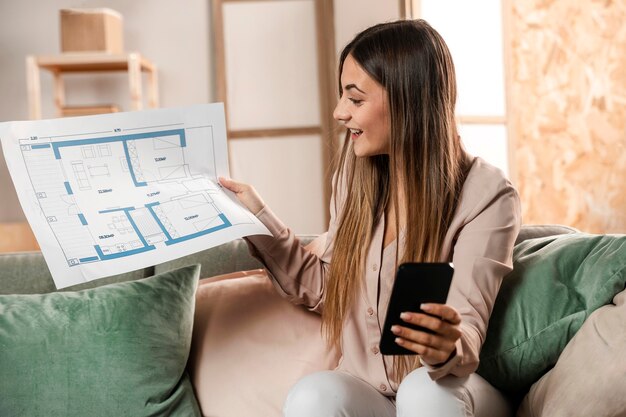 Femme smiley coup moyen avec téléphone et plan