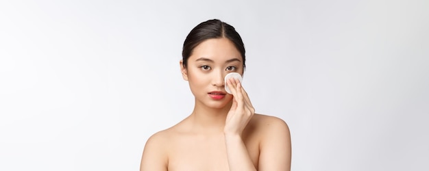 Femme de soins de la peau démaquillant le visage avec un tampon de coton-tige concept de soins de la peau Gros plan du visage d'un beau modèle de race mixte avec une peau parfaite