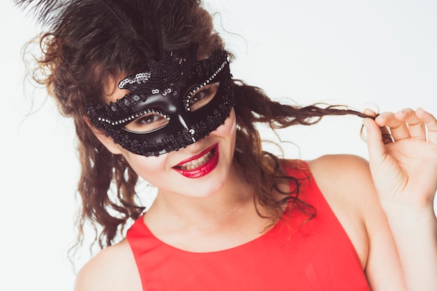 Femme souriante au masque de carnaval noir