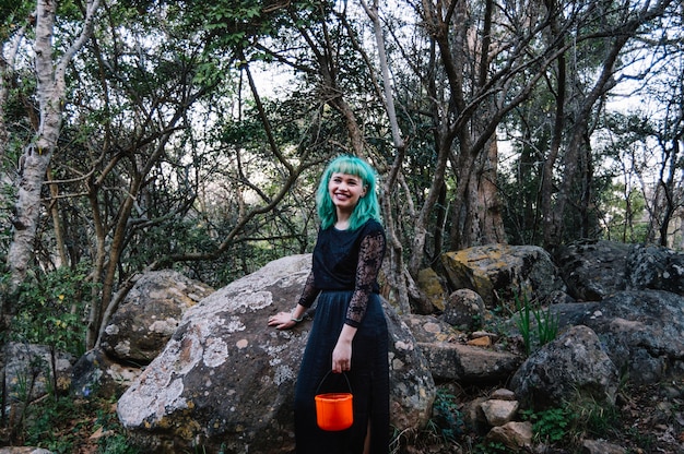 Femme souriante dans la forêt mystérieuse