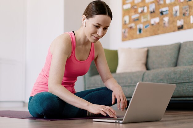 Femme souriante, pratiquer, yoga, chez soi