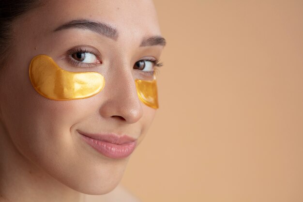 Femme souriante vue de côté avec des pansements oculaires