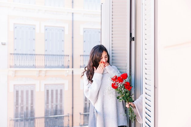 Femme surprise ayant le bouquet de la petite amie