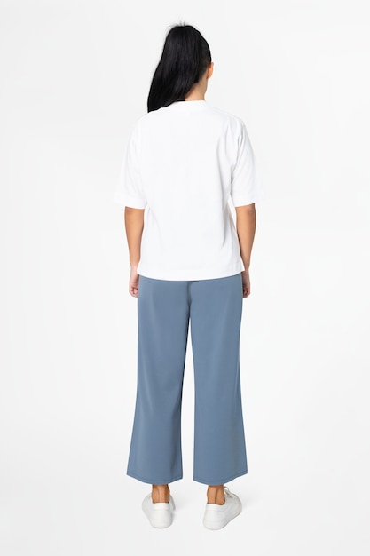 Femme en tee blanc et pantalon ample bleu mode vue arrière minimale