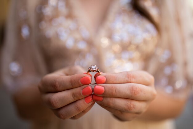 Femme tenant une bague de fiançailles