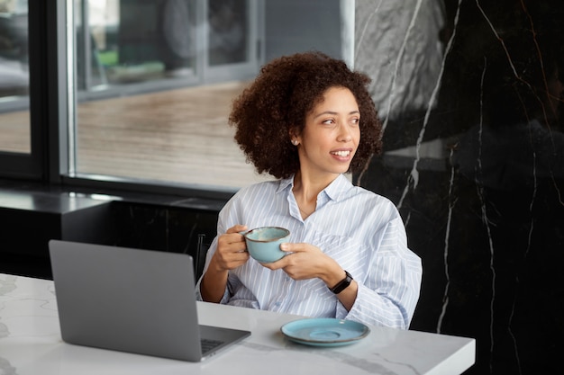 Femme tenant une tasse de café coup moyen