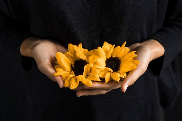 Femme, tenue, jaune, fleurs, mains