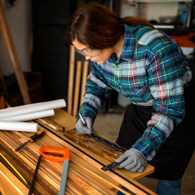 Photo gratuite femme travaillant en atelier avec ruban à mesurer