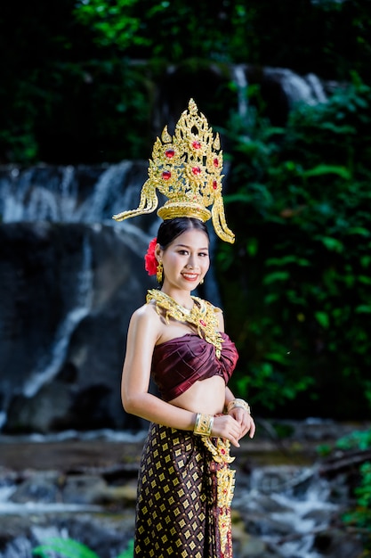 Une femme vêtue d&#39;une ancienne robe thaïlandaise à la cascade.