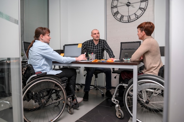 Femmes d'affaires en fauteuil roulant à longue vue