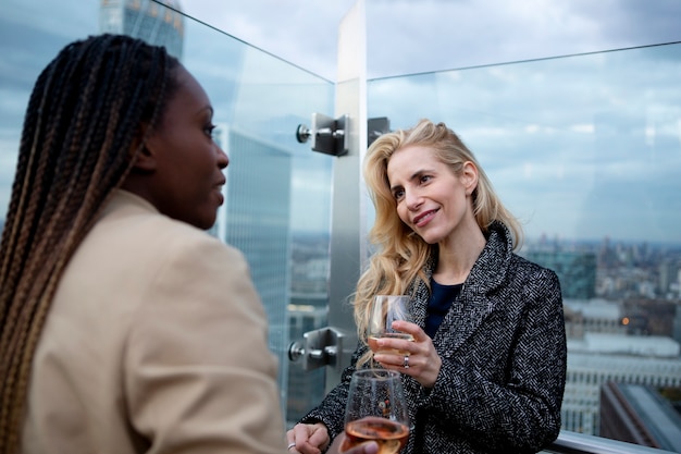 Femmes d'affaires se réunissant à l'extérieur pour prendre un verre