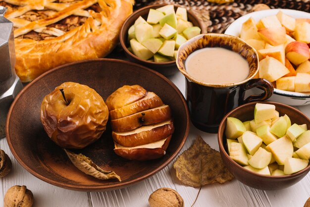 Photo gratuite feuille d'automne couchée près de pommes et boisson