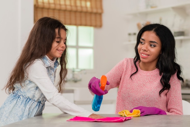 Fille aidant maman à nettoyer