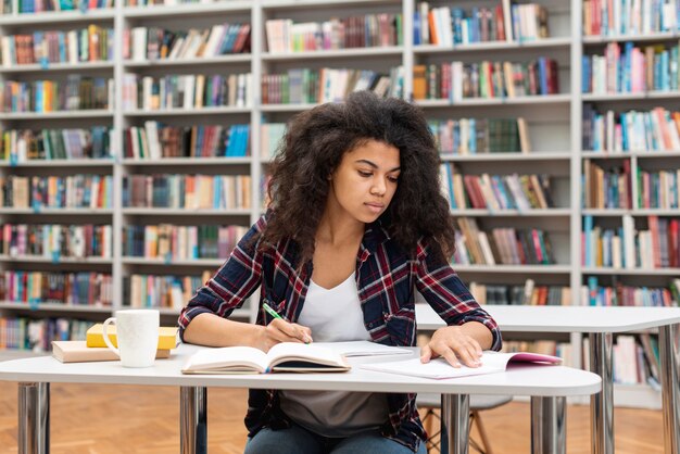 Fille d'angle élevé concentré pour étudier