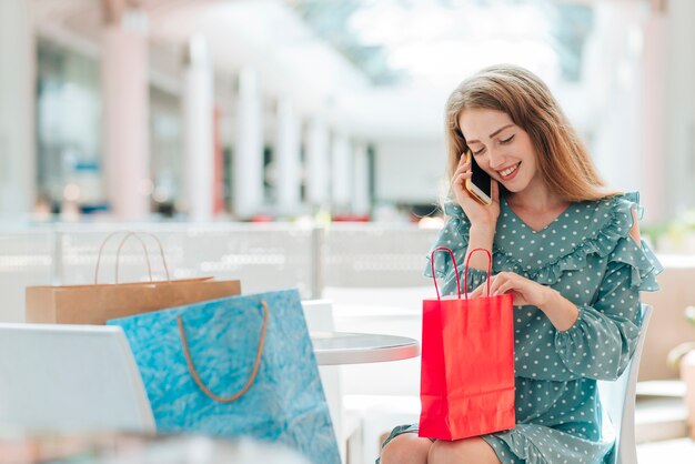 Fille au centre commercial parlant au téléphone