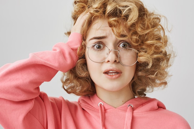 Fille aux cheveux bouclés inquiète et troublée ayant un problème