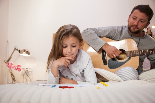 Une fille concentrée regarde son dessin