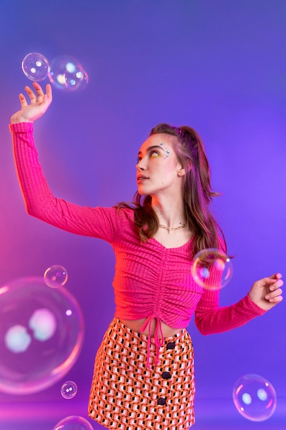 Fille de coup moyen posant avec des bulles