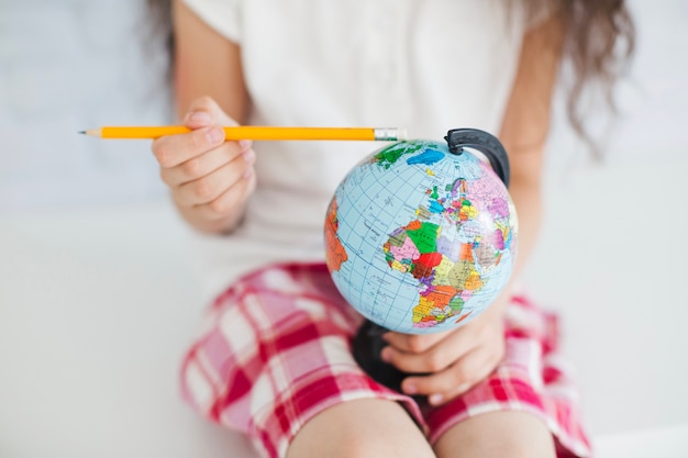 Fille de culture avec crayon et globe