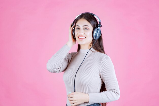 Fille avec des écouteurs, écouter de la musique et se sentir heureux