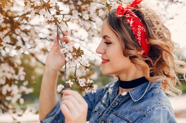 Fille élégante dans un parc de printemps