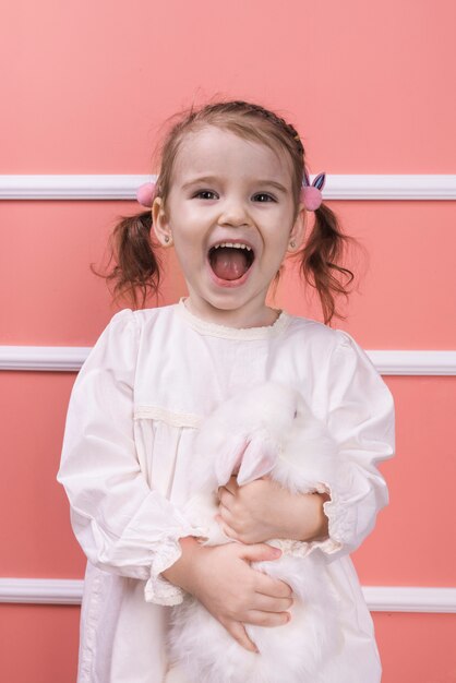 Fille étonnée debout avec lapin