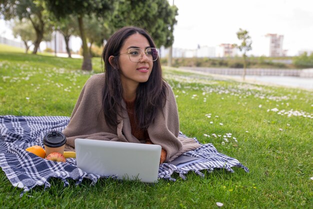 Fille étudiante pensif travaillant sur ordinateur portable