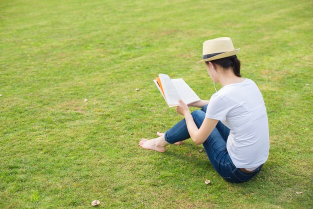 Fille lisant dans le parc