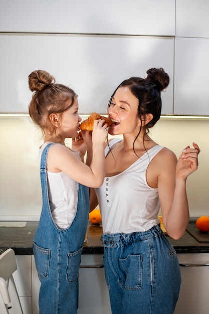 Fille et mère partageant ensemble un délicieux croissant