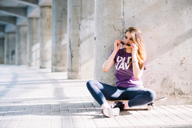 Fille mettant des lunettes de soleil sur