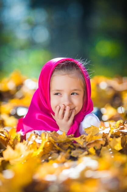 Fille mignonne d'enfant dans un châle et une robe roses, une veste blanche comme Masha et l'ours du dessin animé.