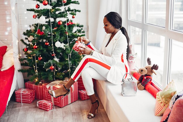 Fille noire élégante dans les décorations de Noël