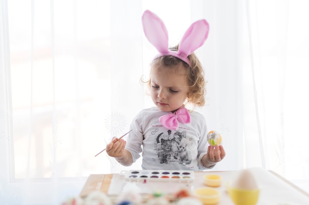 Photo gratuite fille avec des oreilles de lapin en regardant la brosse