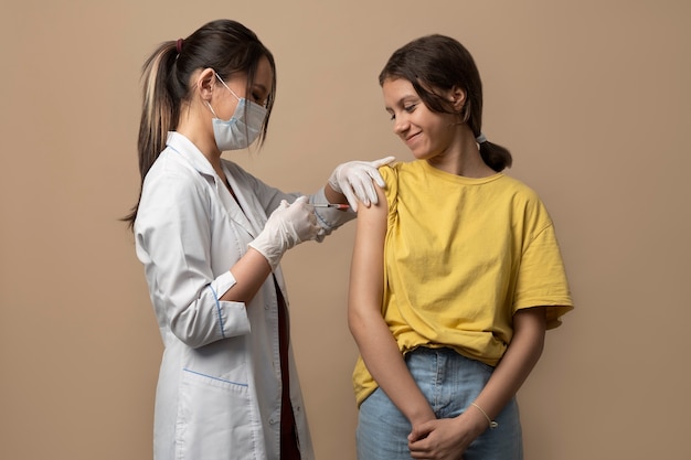 Photo gratuite fille souriante à coup moyen se faire vacciner