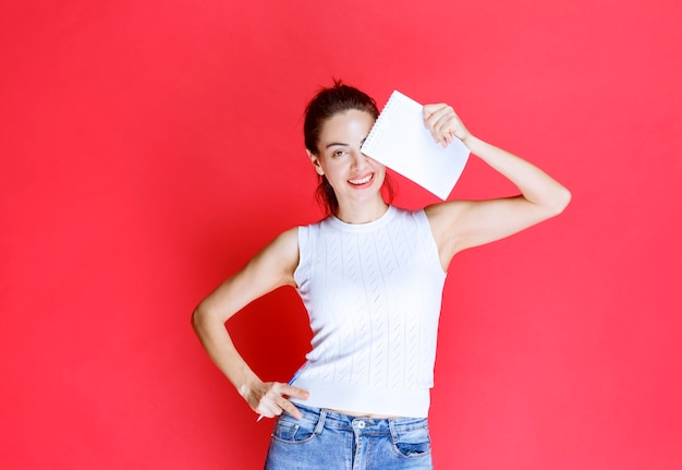 Photo gratuite fille tenant et démontrant sa feuille d'examen.