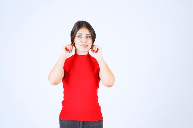 Fille tirant ses oreilles en signe de malchance.