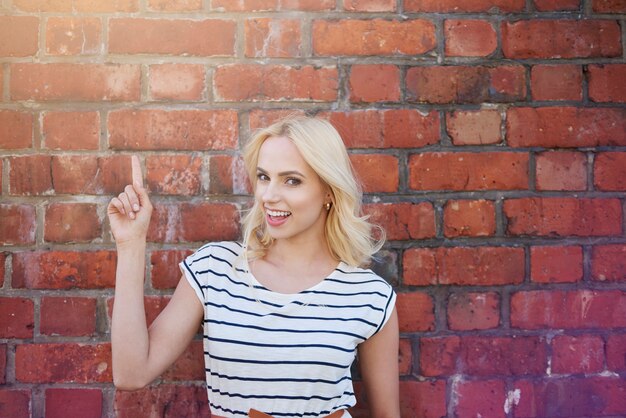 Filles blondes montrant sur un mur vide