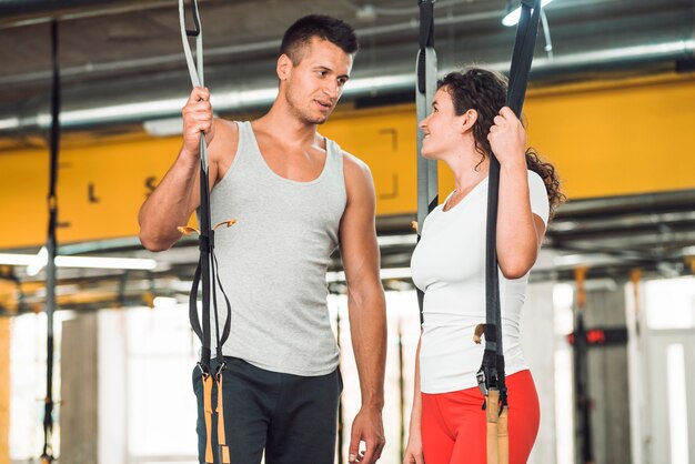 Fit couple se regardant dans la salle de gym